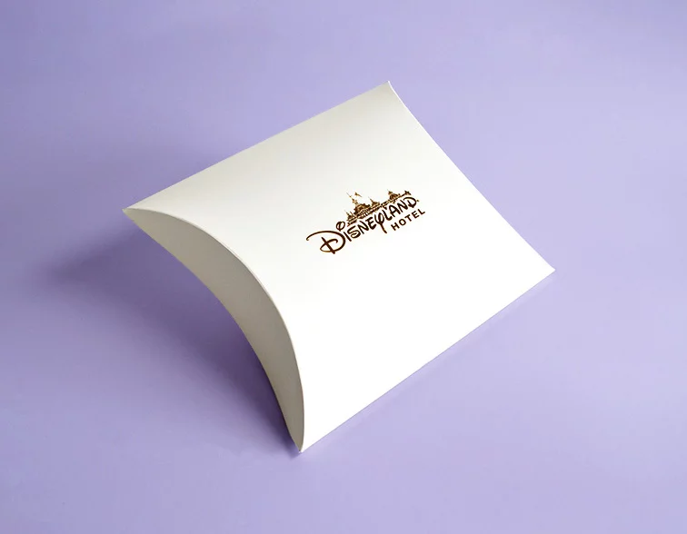 white-custom-made-pillow-box-with-gold-logo-on-purple-bacground